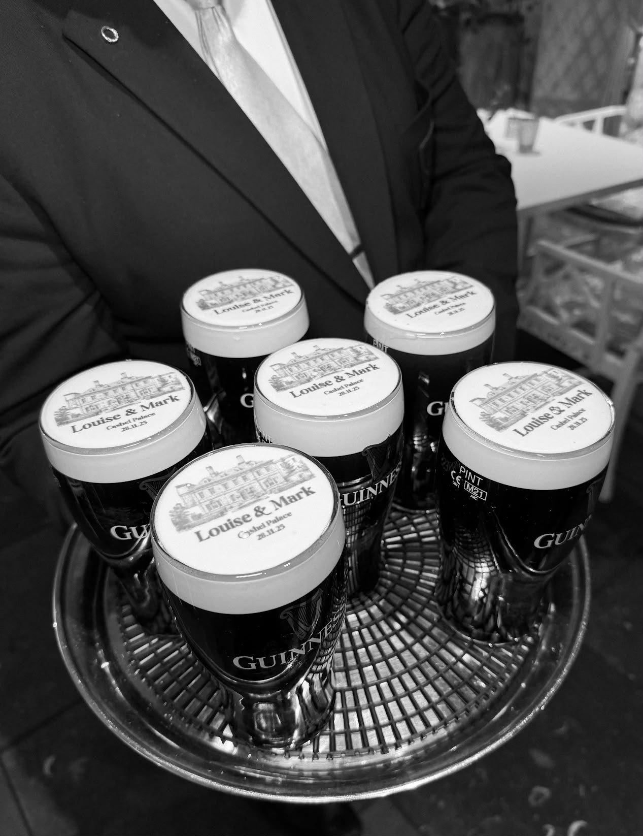 A tray of wedding pints featuring detailed venue illustrations